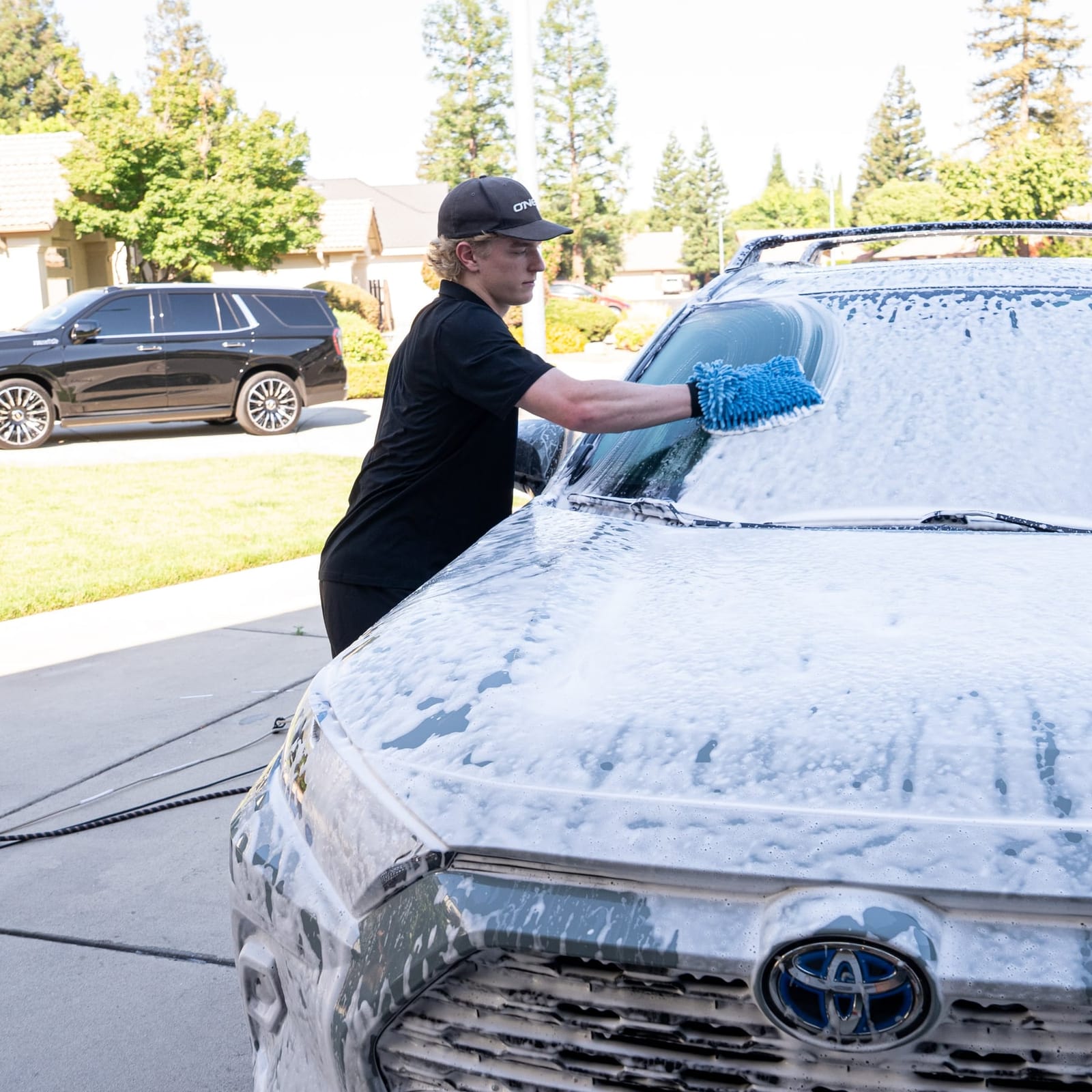 Moonstone Mobile Detailing hand washing a soapy car in Fresno, CA